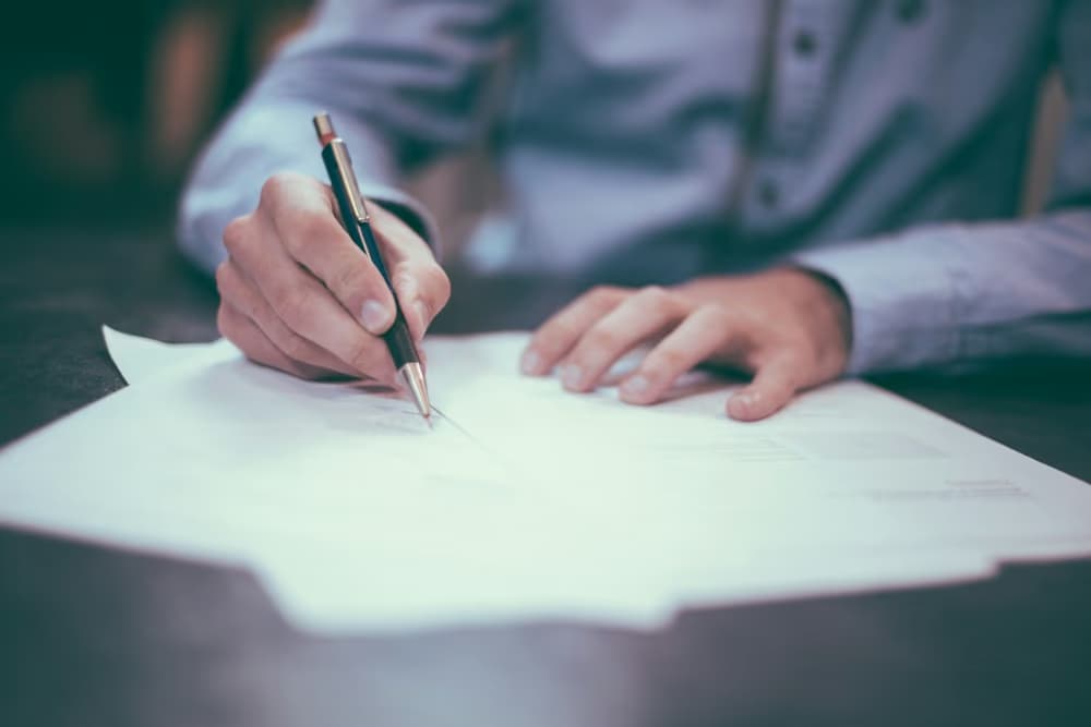 A professional signing business documents