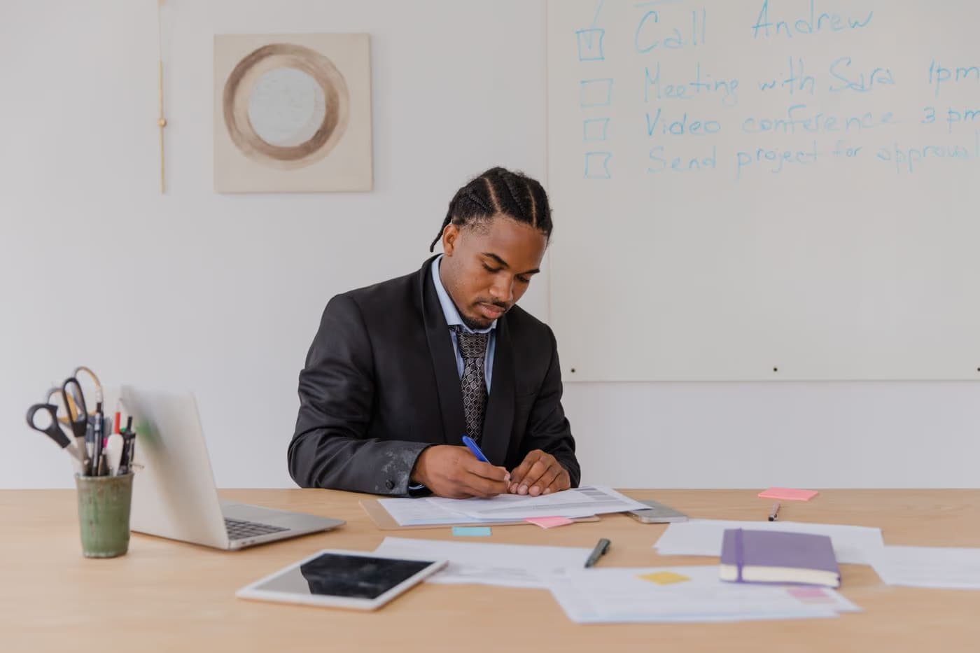 A business professional reviewing paperwork at an office desk
