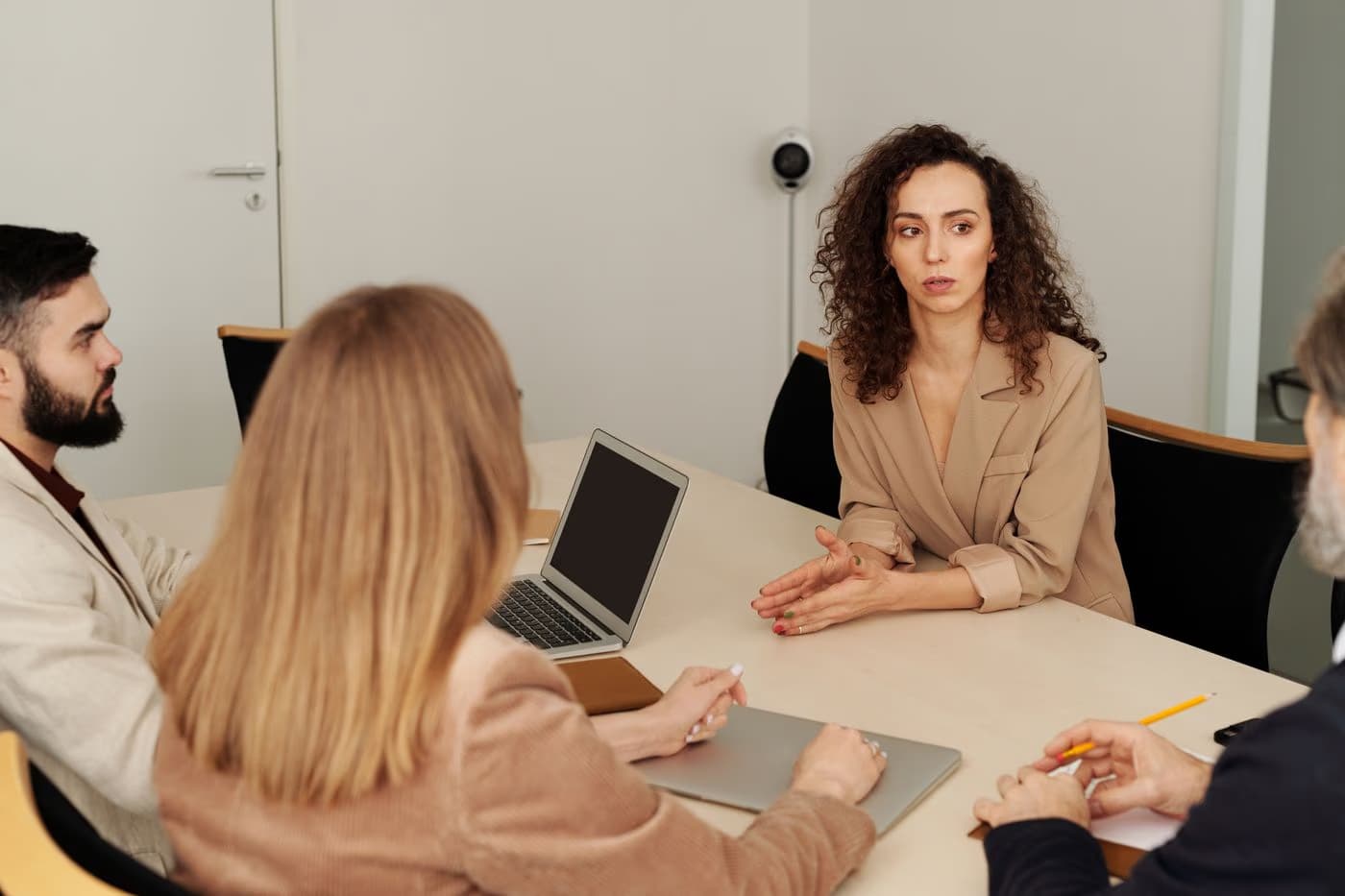 Business professionals discussing plans around a meeting table