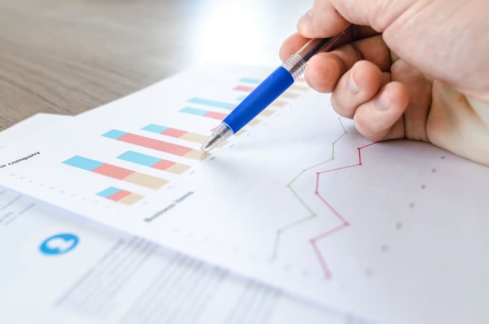 A financial report being reviewed with a pen